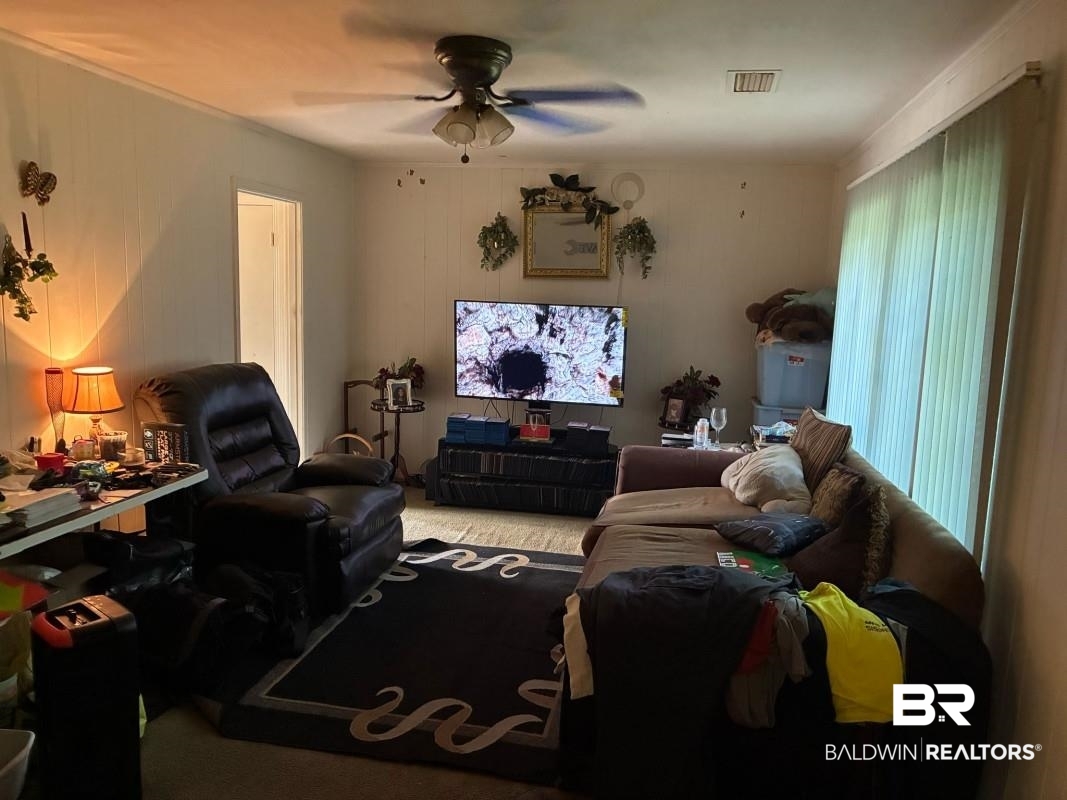 514 Nantucket Circle Mobile, AL 36609 - Photo 2 of 13 Living room with carpet flooring, visible vents, and ceiling fan