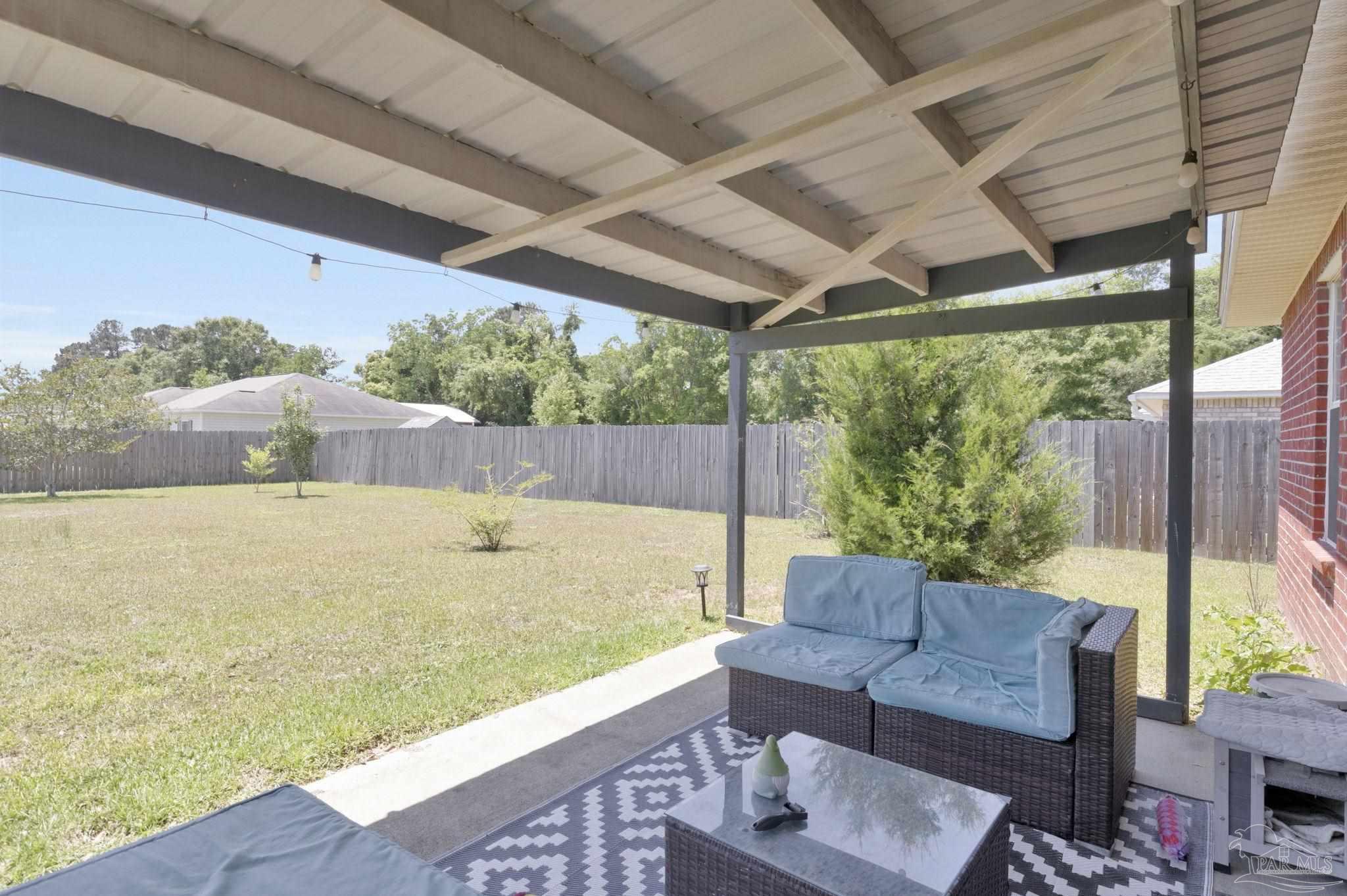 5539 Windrun Place Pace, FL 32571 - Photo 37 of 62 a view of a swimming pool with a couches in a patio