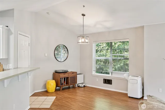a living room with dining table and a window