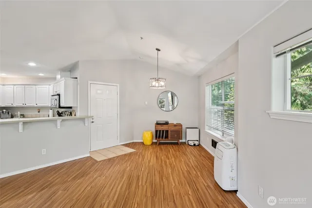 a view of a room with wooden floor and windows