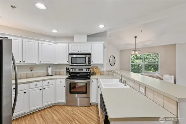 a kitchen with wooden cabinets and white appliances