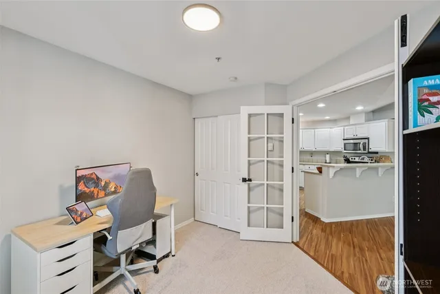 a view of a kitchen with refrigerator and workspace