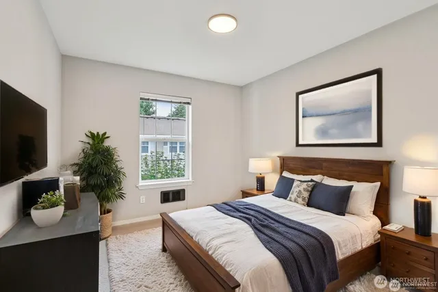 a bedroom with bed windows and a potted plant