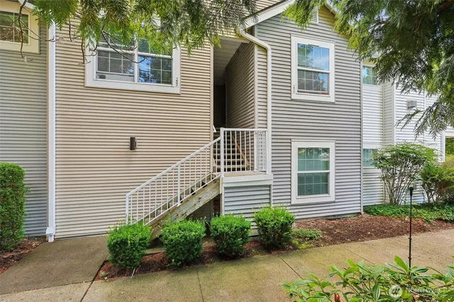 a view of a house with a yard and plants