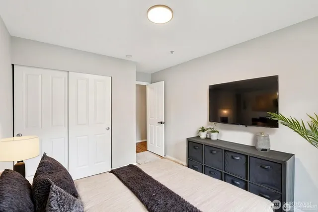 a bedroom with a bed and a flat screen tv