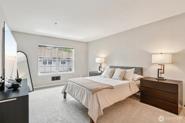 a bedroom with a bed and a window