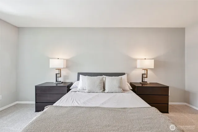 a bedroom with a bed and a lamp