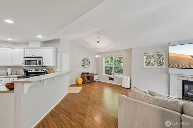 a living room with furniture a fireplace and a flat screen tv