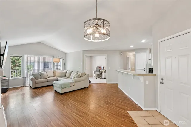a living room with furniture wooden floor and a chandelier
