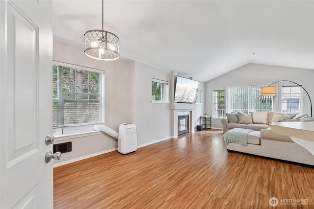 a living room with fireplace furniture and a wooden floor