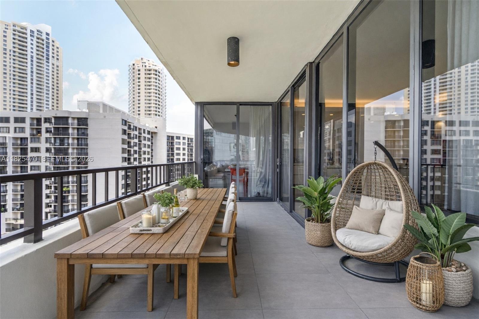a view of a balcony with chairs and potted plants