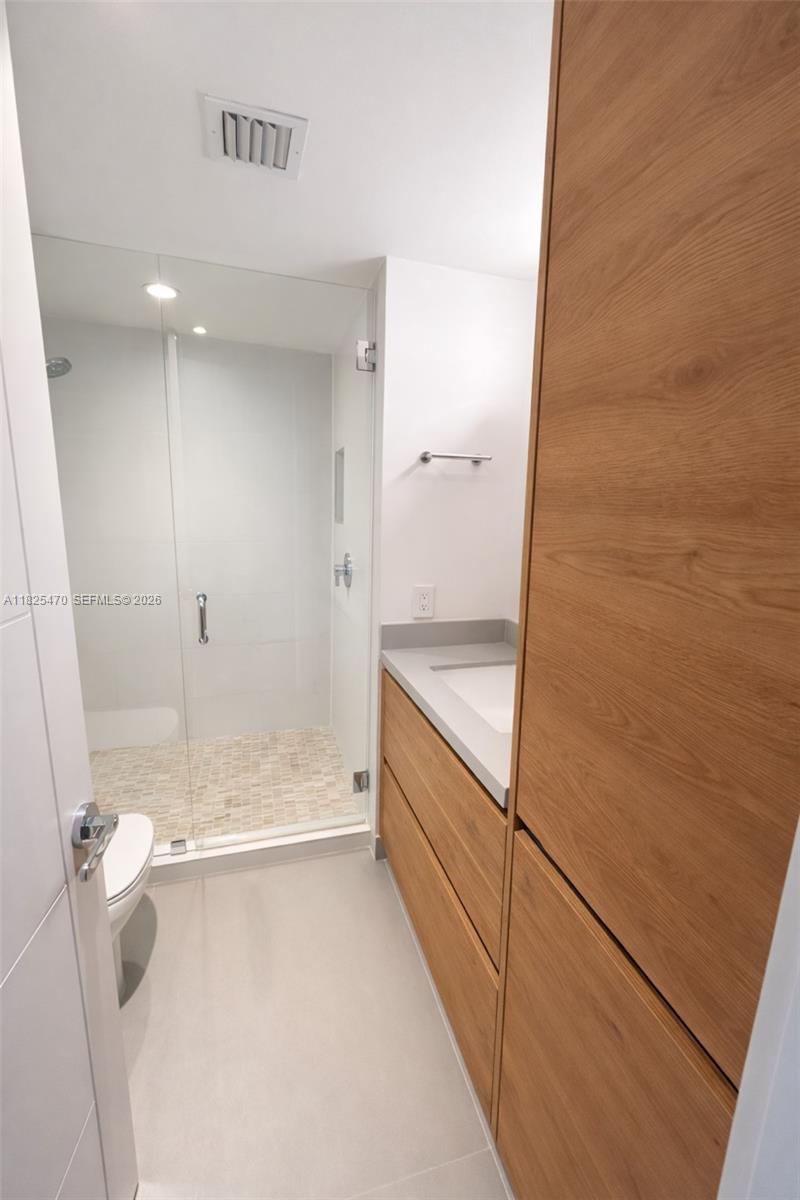 520 Brickell Key Drive, Unit A1421 Miami, FL 33131 - Photo 11 of 16 a bathroom with a bathtub and a shower
