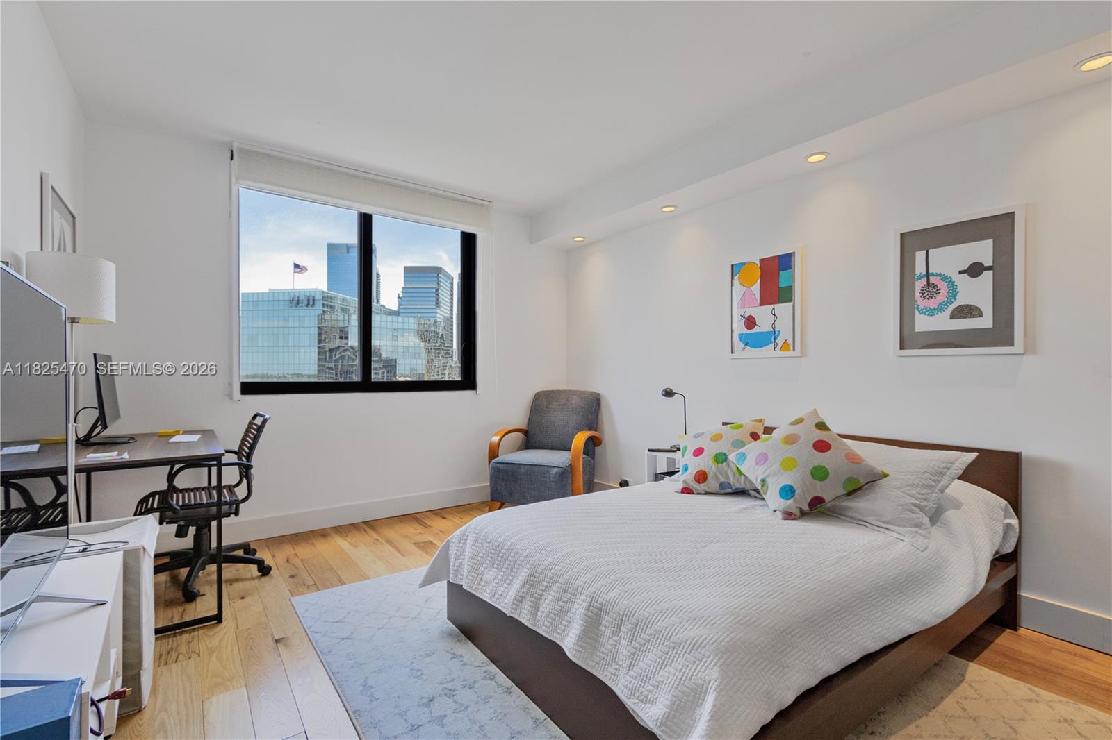 520 Brickell Key Drive, Unit A1421 Miami, FL 33131 - Photo 12 of 16 a bedroom with a bed and wooden floor
