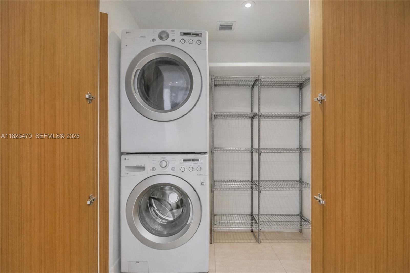 520 Brickell Key Drive, Unit A1421 Miami, FL 33131 - Photo 14 of 16 a utility room with dryer and washer