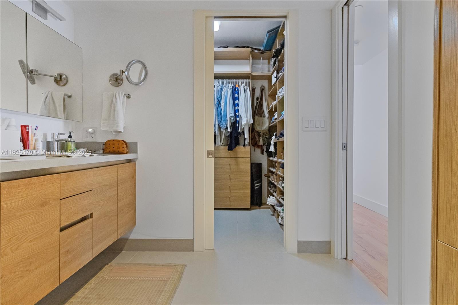 520 Brickell Key Drive, Unit A1421 Miami, FL 33131 - Photo 16 of 34 a bathroom with a sink and a mirror