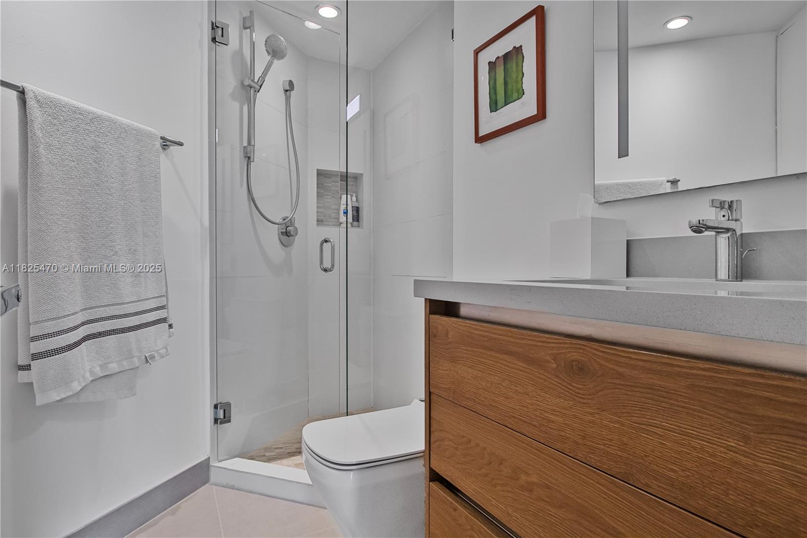 520 Brickell Key Drive, Unit A1421 Miami, FL 33131 - Photo 26 of 34 a bathroom with a granite countertop sink toilet and shower