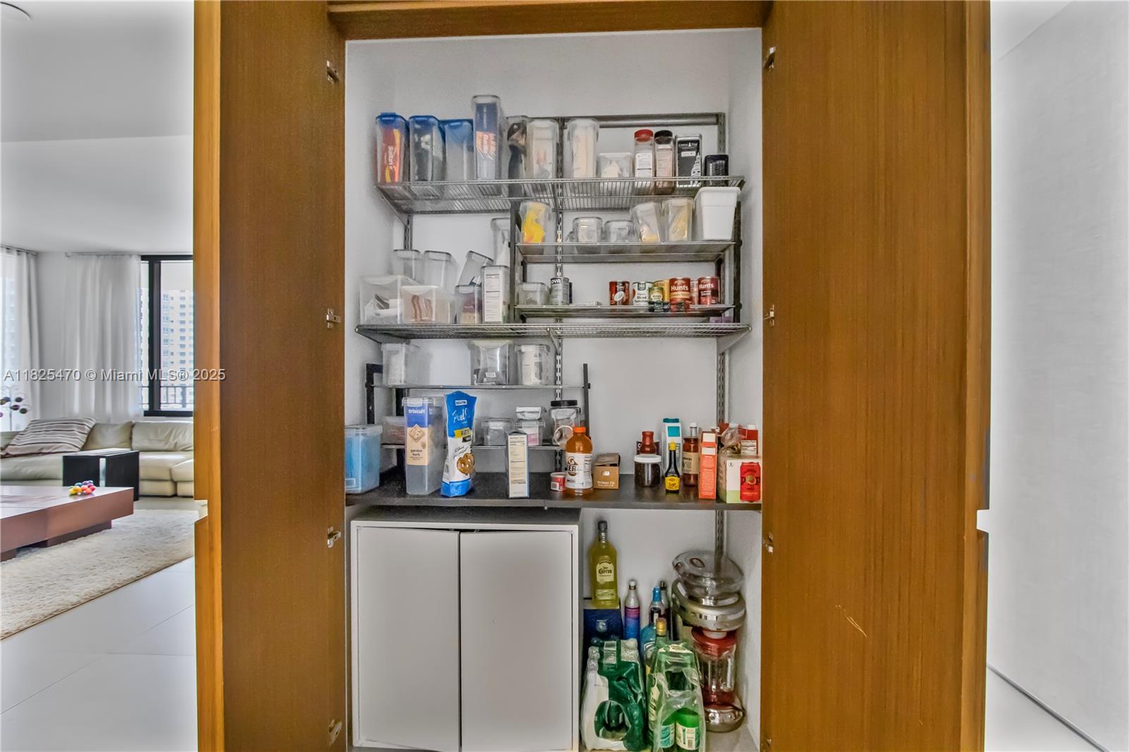 520 Brickell Key Drive, Unit A1421 Miami, FL 33131 - Photo 28 of 34 a kitchen with lots of bottles of alcohol