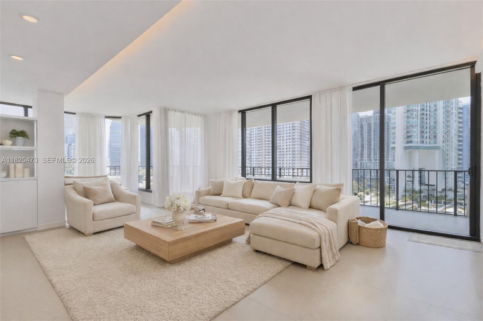 520 Brickell Key Drive, Unit A1421 Miami, FL 33131 - Photo 3 of 16 a living room with furniture and a large window