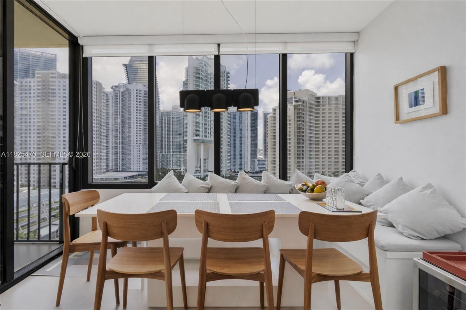 520 Brickell Key Drive, Unit A1421 Miami, FL 33131 - Photo 4 of 16 a view of a dining room with furniture window and outside view