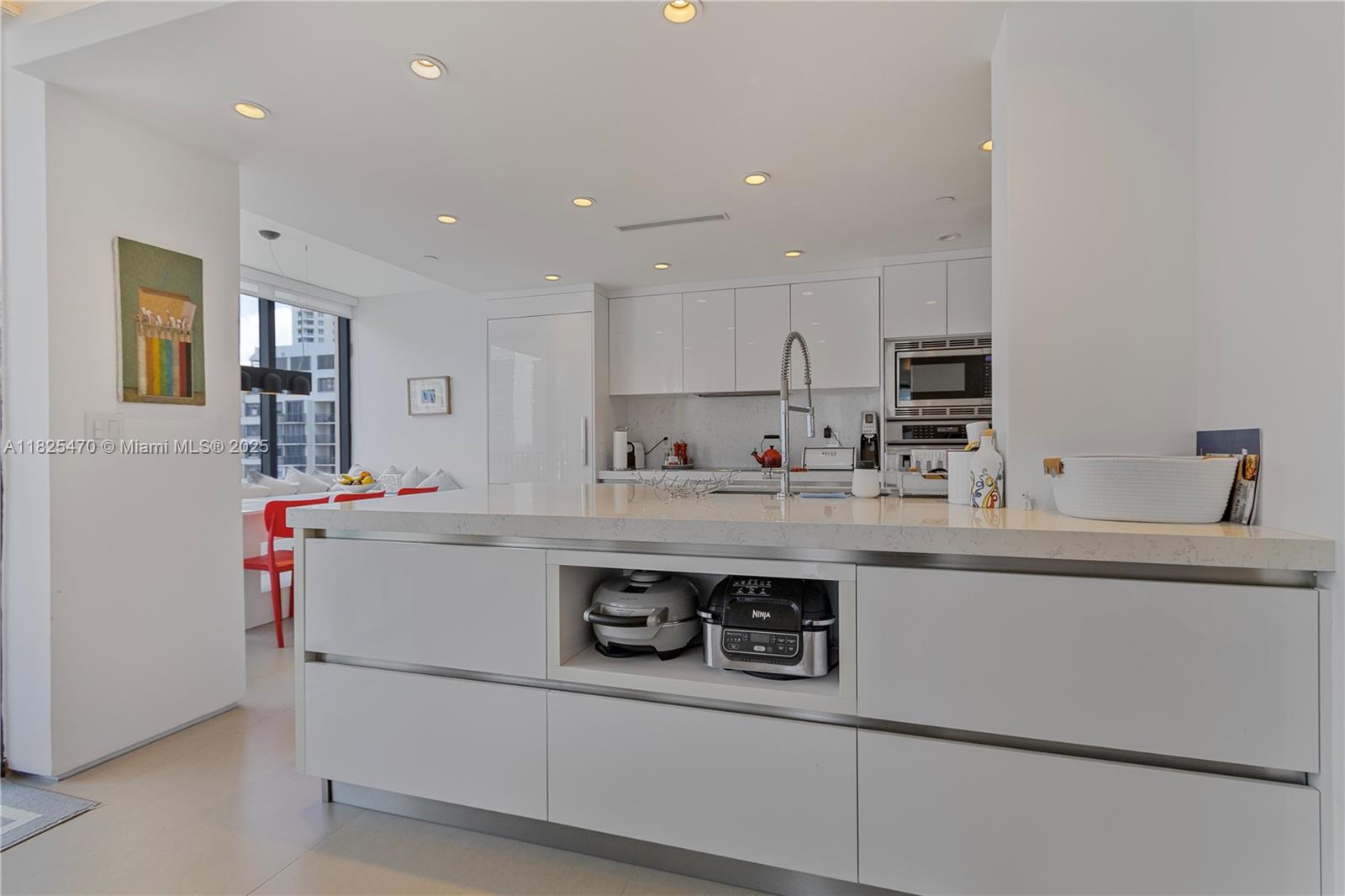 520 Brickell Key Drive, Unit A1421 Miami, FL 33131 - Photo 4 of 34 a kitchen with a sink a stove and cabinets