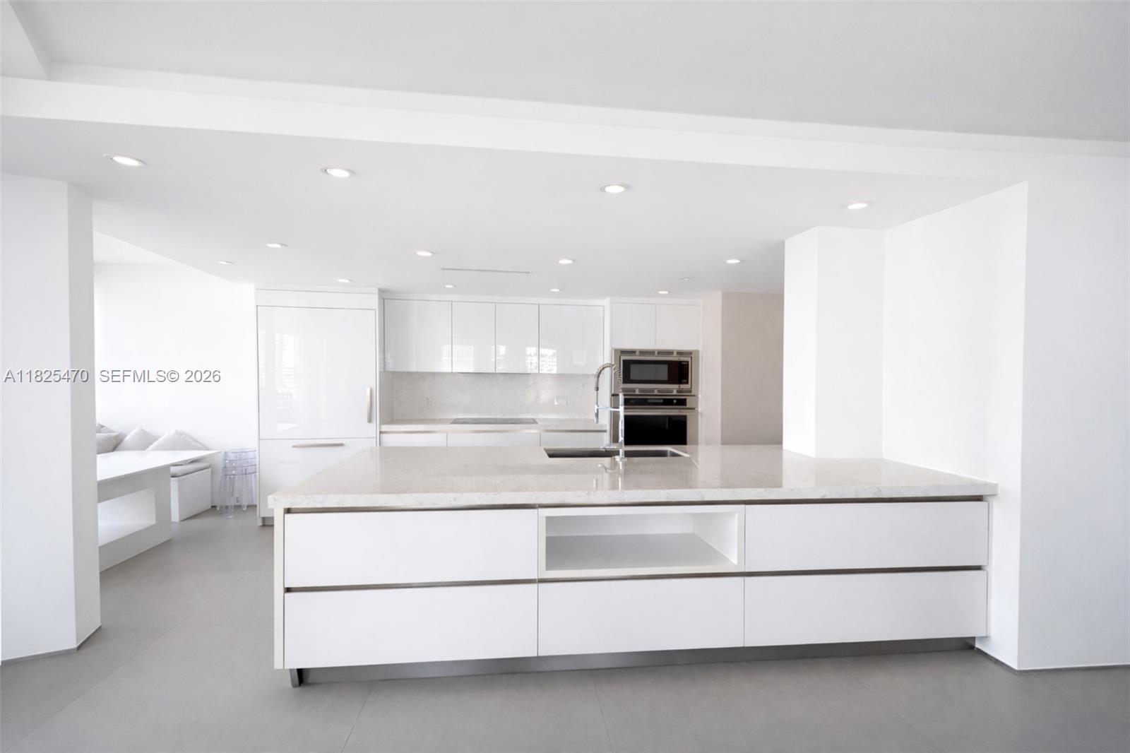 520 Brickell Key Drive, Unit A1421 Miami, FL 33131 - Photo 5 of 16 a living room with a furniture and a kitchen view