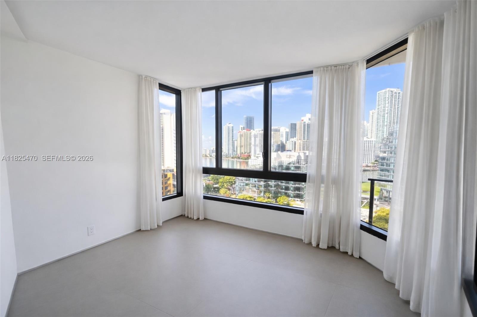 520 Brickell Key Drive, Unit A1421 Miami, FL 33131 - Photo 6 of 16 a view of room with floor to ceiling window