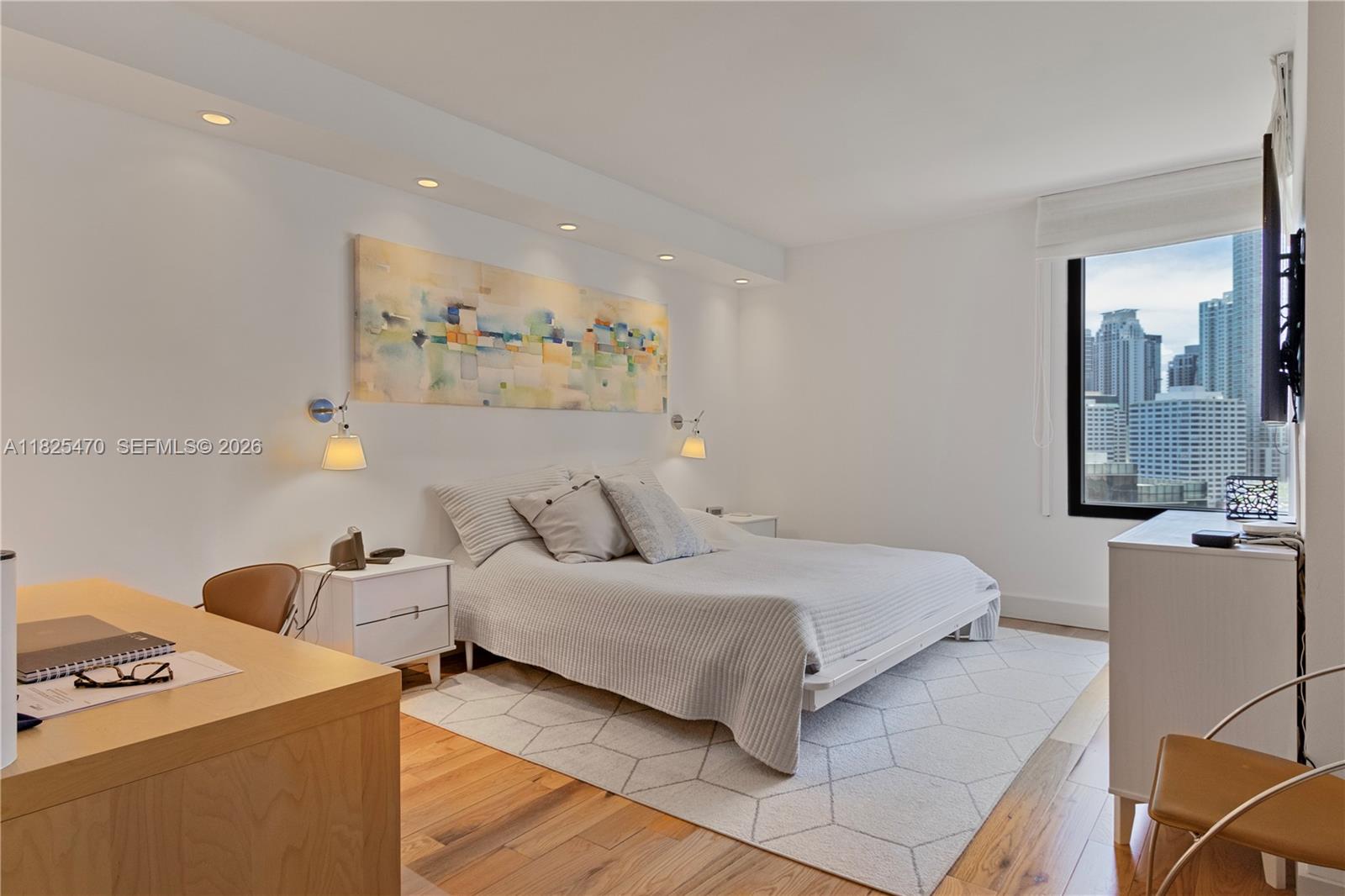 520 Brickell Key Drive, Unit A1421 Miami, FL 33131 - Photo 7 of 16 a bedroom with a bed and a cabinets