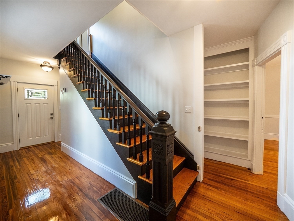 12 Adella Place Boston, MA 02134 - Photo 13 of 36 a view of a hallway with wooden floor and stairs