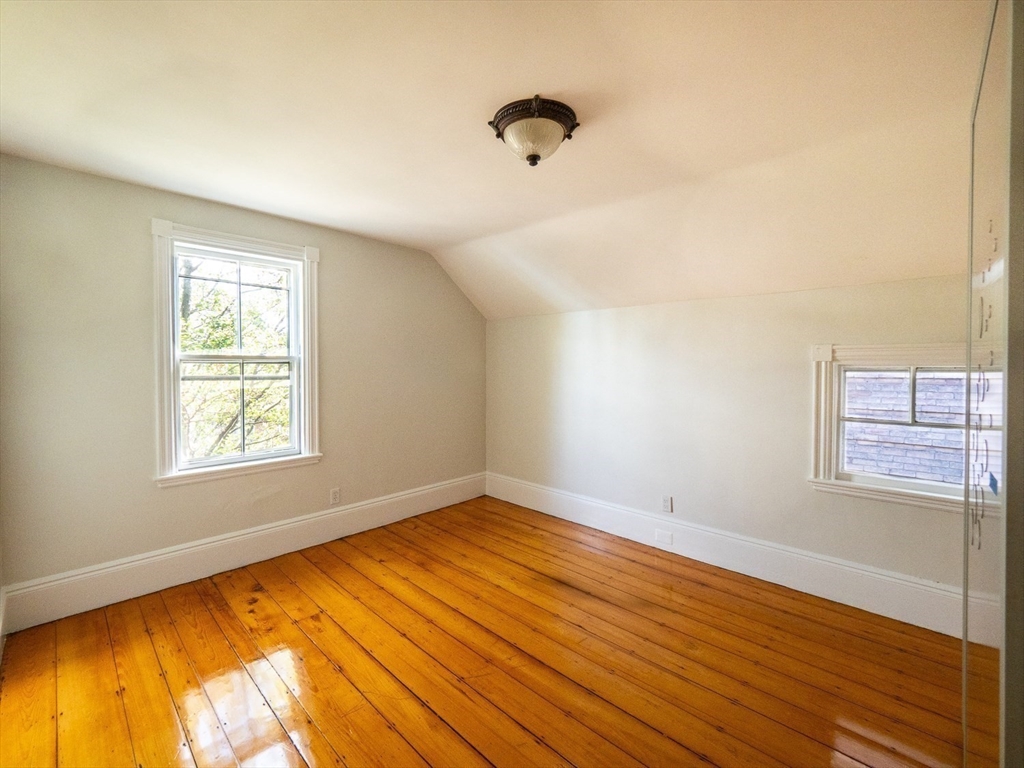 12 Adella Place Boston, MA 02134 - Photo 16 of 36 a view of an empty room with wooden floor and a window