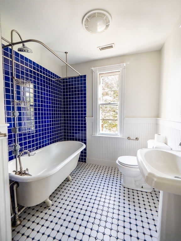 12 Adella Place Boston, MA 02134 - Photo 18 of 36 a bathroom with a sink a bathtub and a toilet