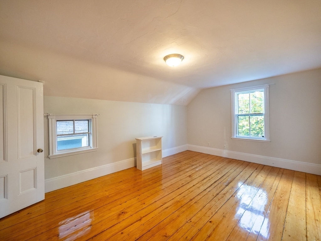 12 Adella Place Boston, MA 02134 - Photo 22 of 36 an empty room with wooden floor and windows