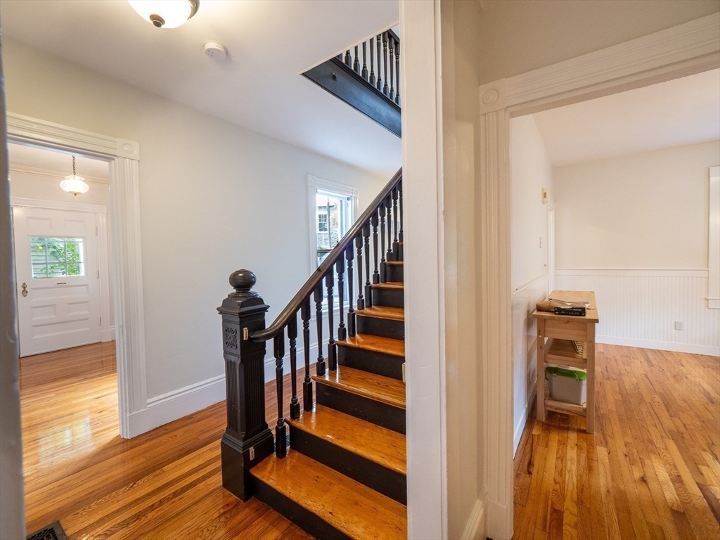 12 Adella Place Boston, MA 02134 - Photo 9 of 36 a view of a hallway with wooden floor and staircase