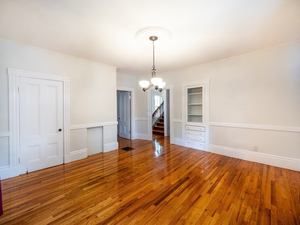 12 Adella Place Boston, MA 02134 - Photo 10 of 36 a view of a livingroom with wooden floor and a ceiling fan