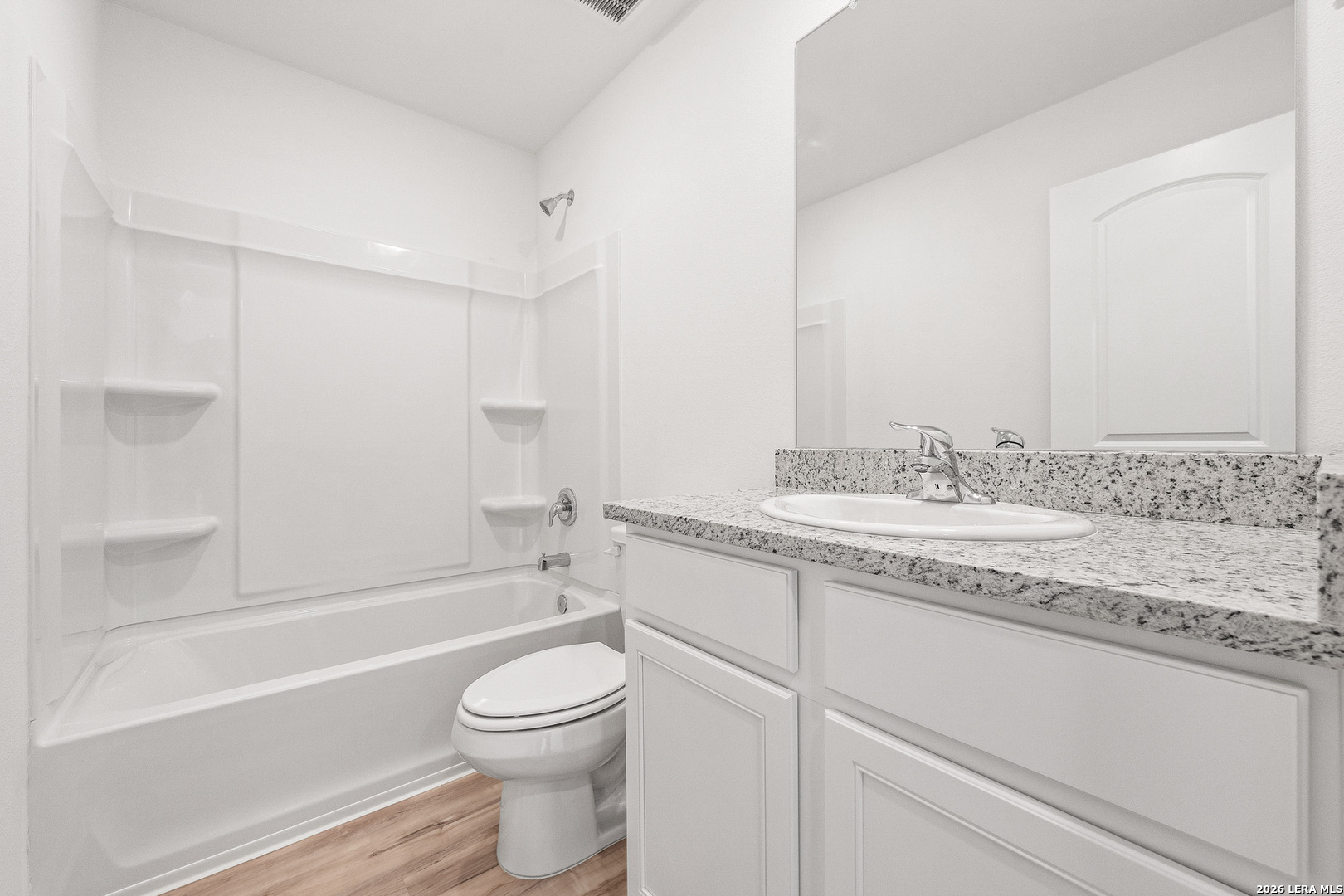 16189 Farmer Lytle, TX 78052 - Photo 17 of 28 a bathroom with a granite countertop sink a toilet and bathtub