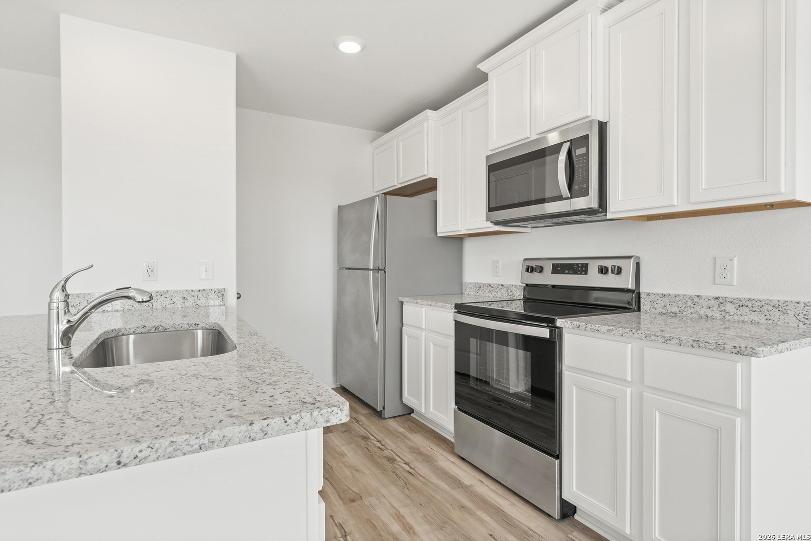 16189 Farmer Lytle, TX 78052 - Photo 4 of 28 a kitchen with stainless steel appliances granite countertop a sink and a microwave