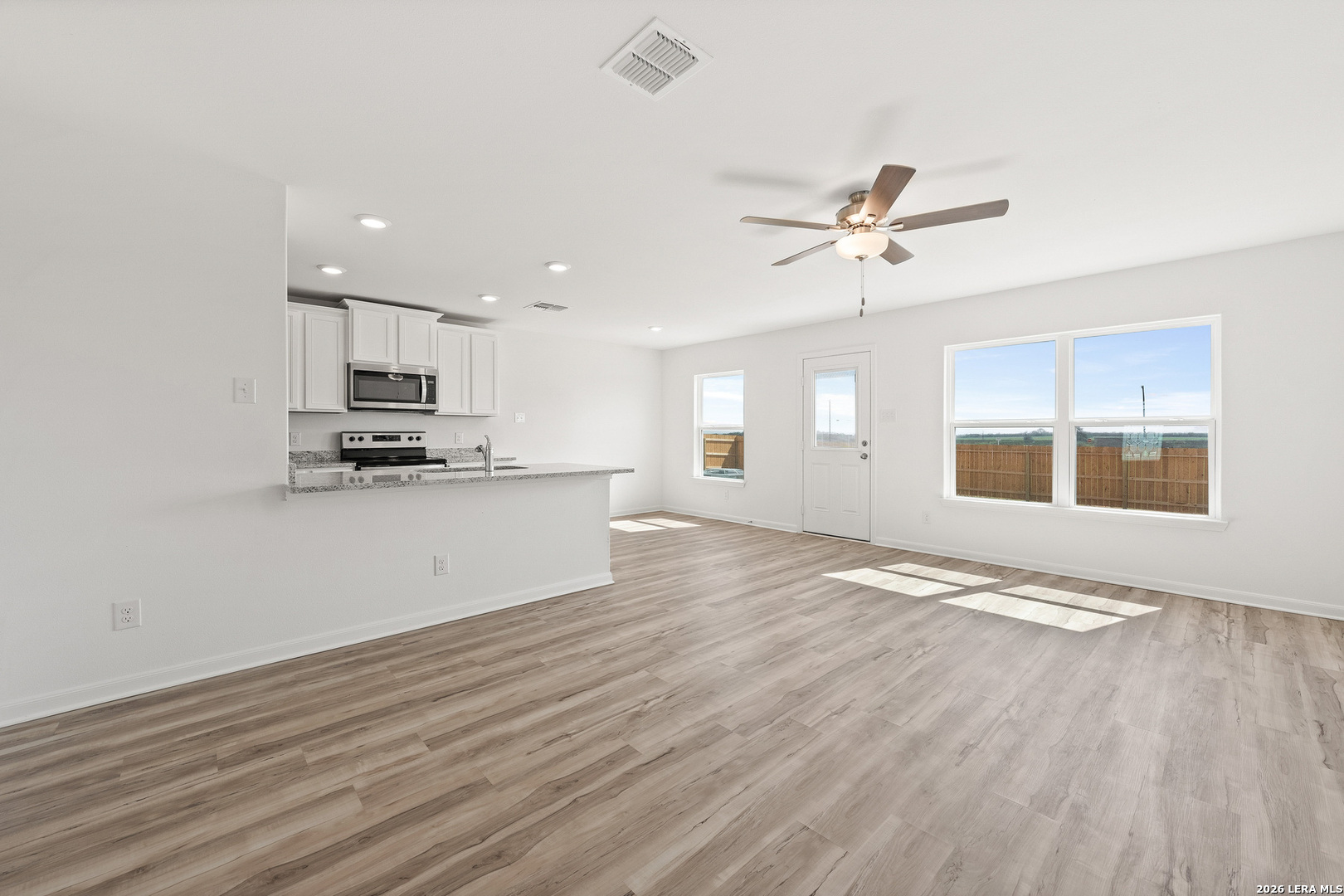 16189 Farmer Lytle, TX 78052 - Photo 8 of 28 a view of kitchen with granite countertop cabinets and wooden floor