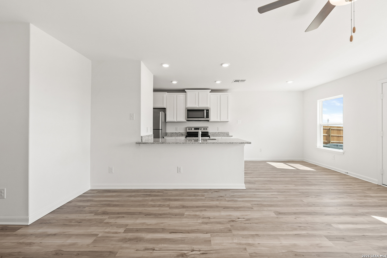 16189 Farmer Lytle, TX 78052 - Photo 9 of 28 a view of kitchen with granite countertop cabinets and wooden floor