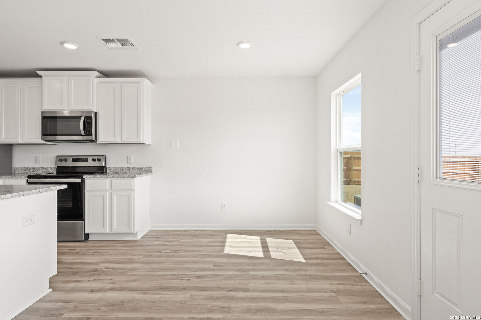 16189 Farmer Lytle, TX 78052 - Photo 10 of 28 a kitchen with a refrigerator and a stove top oven