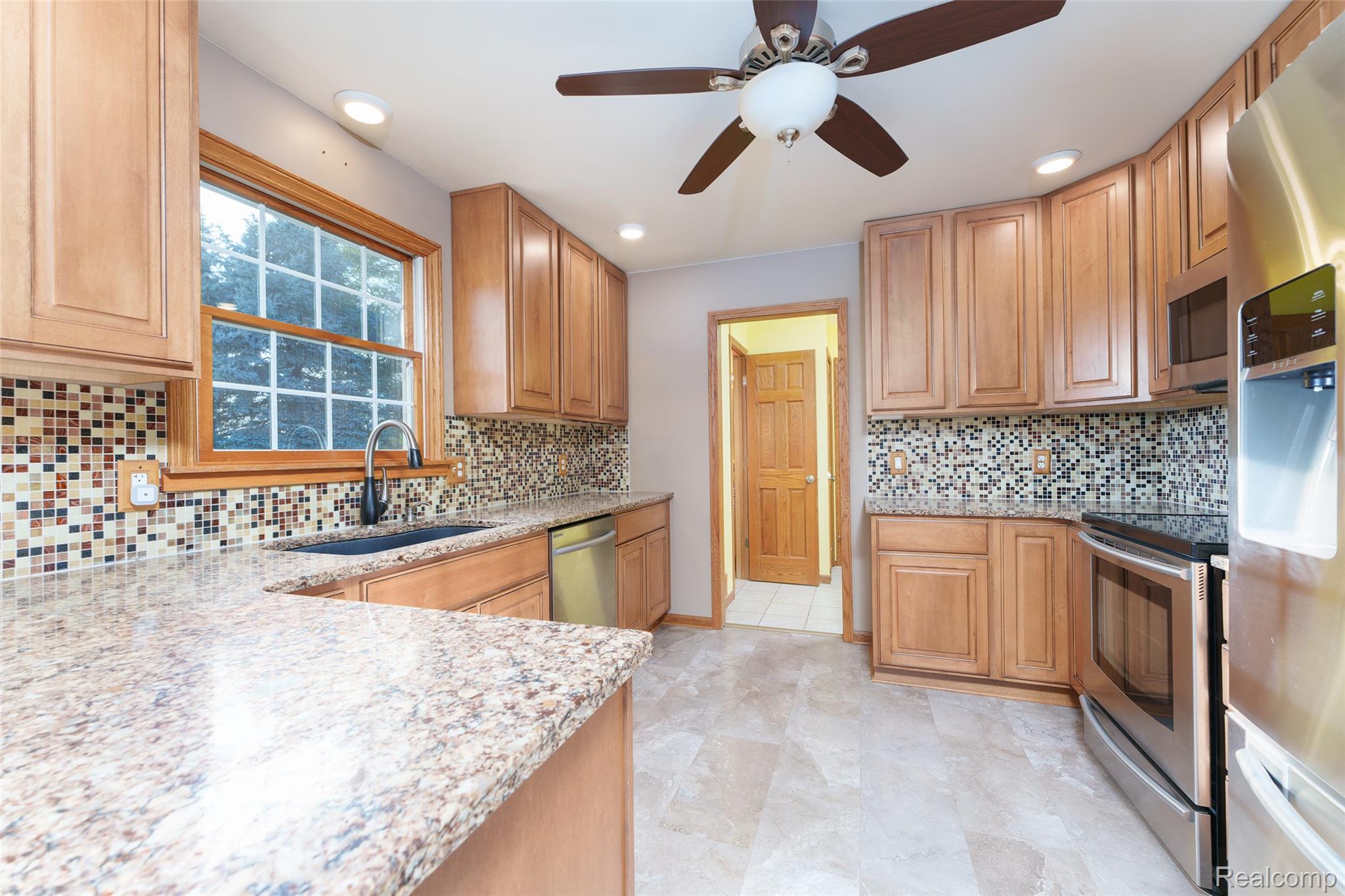 Updated kitchen with quartz counters, backsplash and stainless appliances