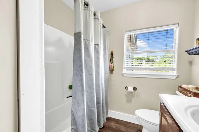 a bathroom with a sink toilet and a mirror