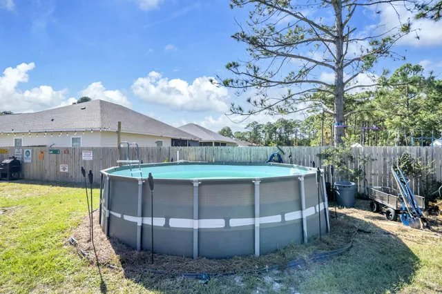a view of a yard with swimming pool