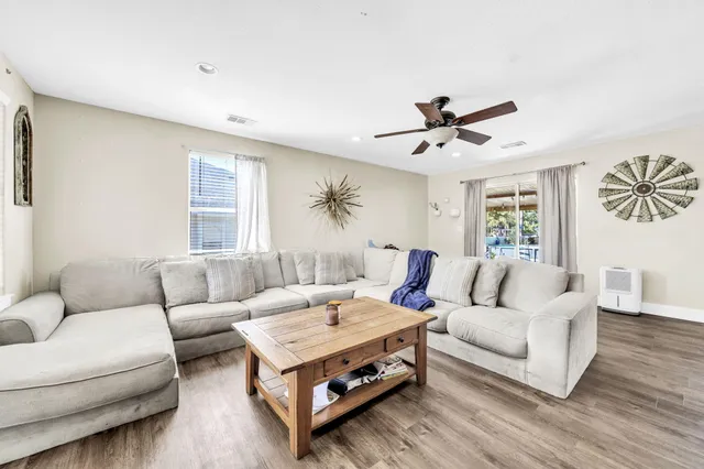 a view of a patio with table and chairs with wooden floor and fence