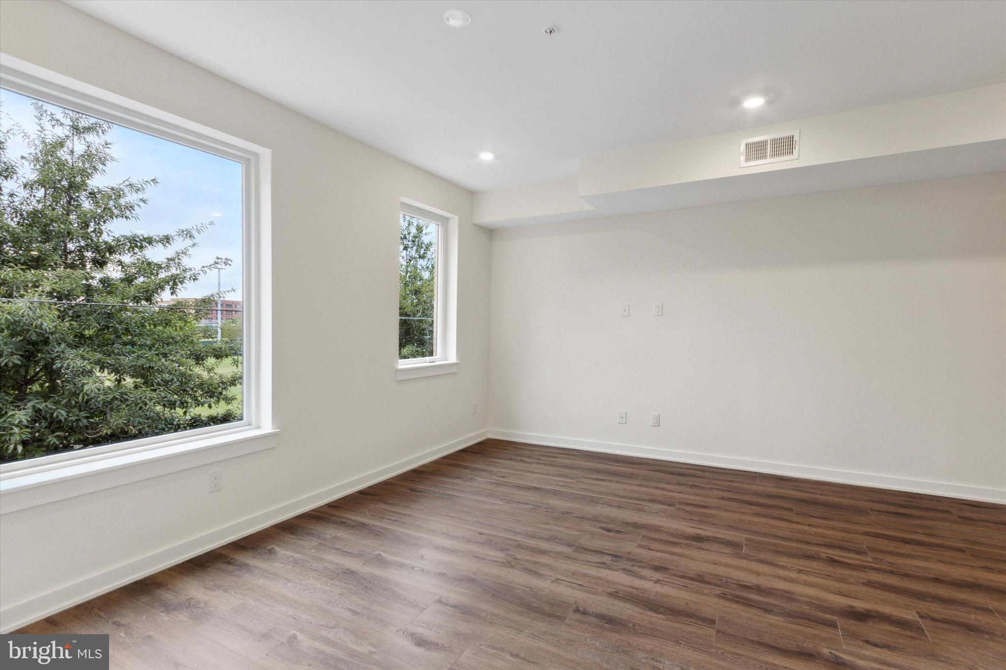 1826 Frankford Avenue, Unit 3 Philadelphia, PA 19125 - Photo 12 of 18 a view of an empty room with wooden floor and a window