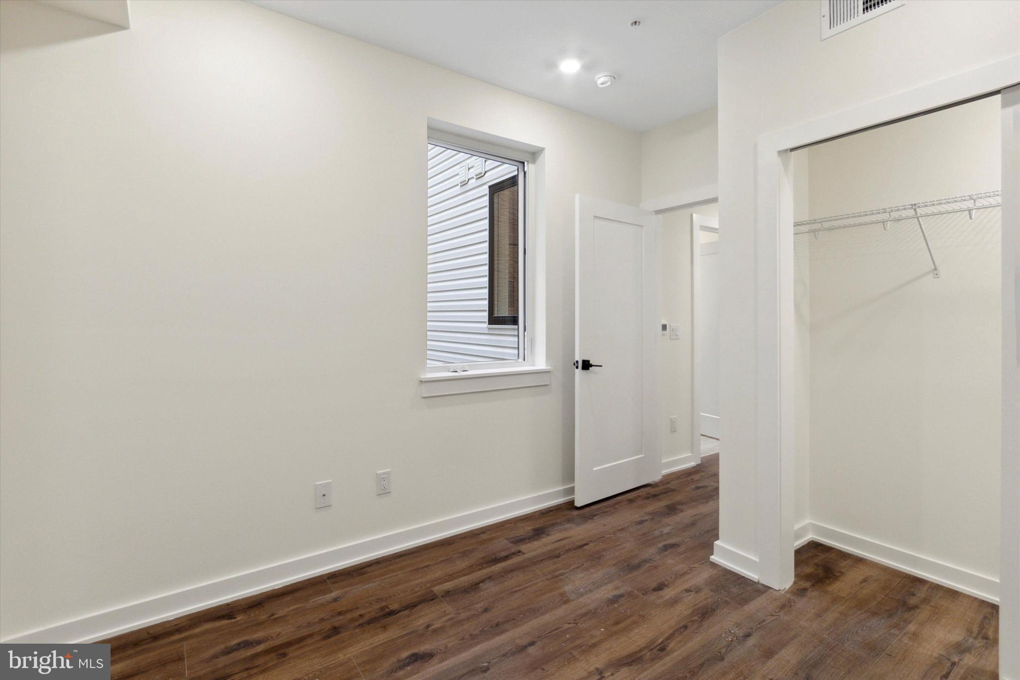 1826 Frankford Avenue, Unit 3 Philadelphia, PA 19125 - Photo 16 of 18 an empty room with wooden floor and windows