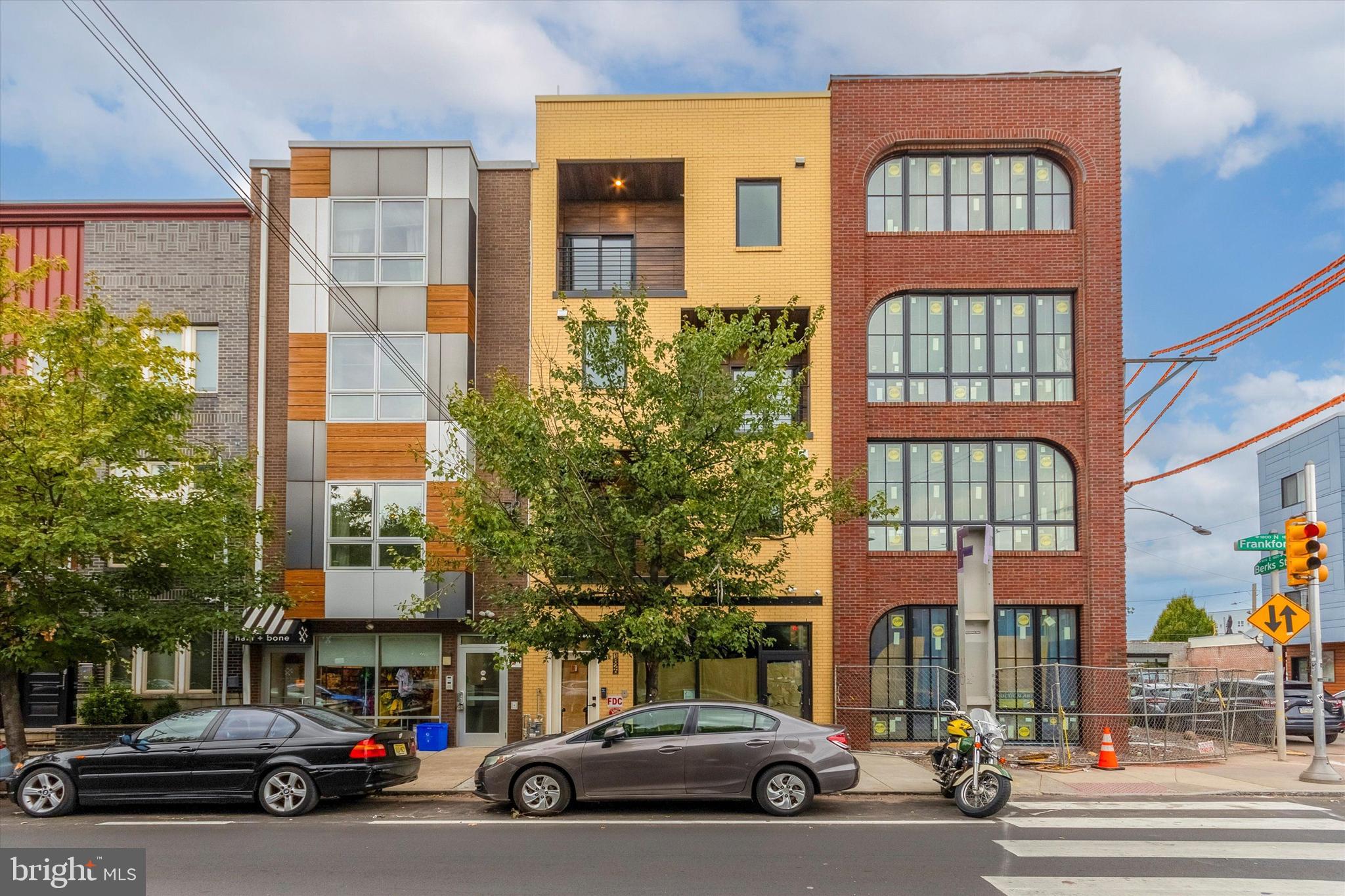 1826 Frankford Avenue, Unit 3 Philadelphia, PA 19125 - Photo 6 of 18 a city street lined with buildings and cars parked
