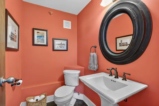 a bathroom with a sink a mirror and a toilet
