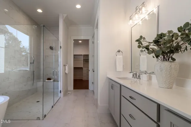 a view of an empty room with a window and dresser