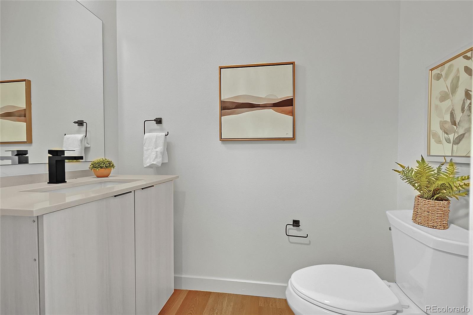 765 East County Line Road Erie, CO 80516 - Photo 11 of 28 a bathroom with a toilet a sink and mirror