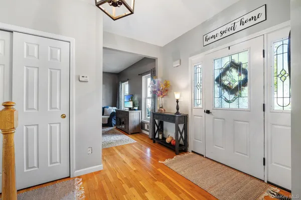 a view of a hallway with wooden floor and windows
