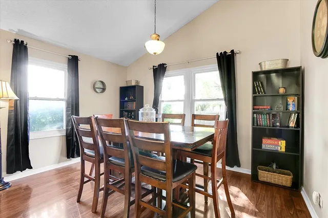 a living room with furniture floor to ceiling window and potted plants